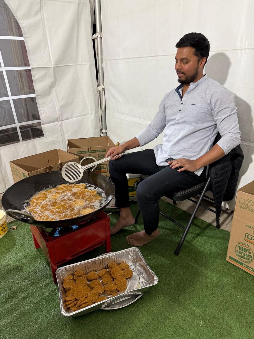 A tray of fresh Thekua beside the kadhai in the BAJCCA tent